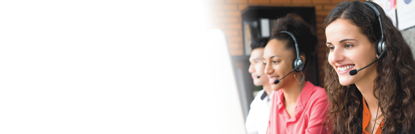 Smiling businesswoman working in call center with her multiethnic colleagues