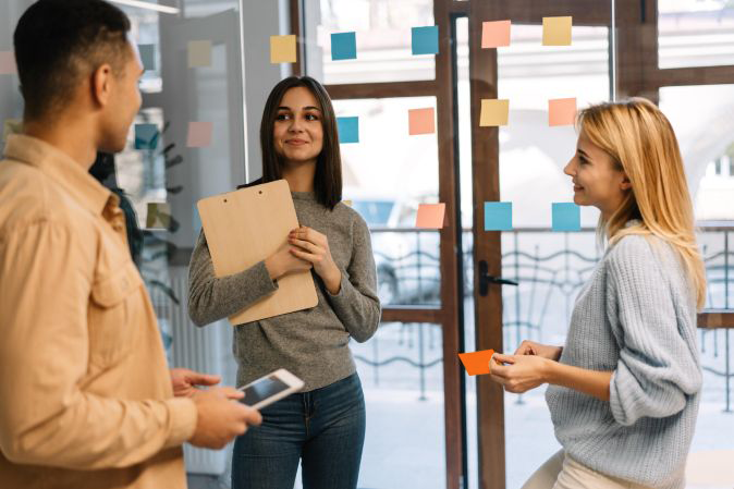 Three college students brainstorming together in class