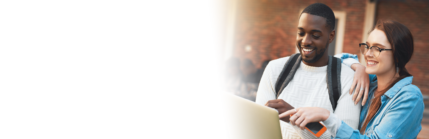 Interracial couple, students and watching with laptop for social media or online streaming at campus. Happy, man and woman with smile or backpack on computer for research, browsing or app at college