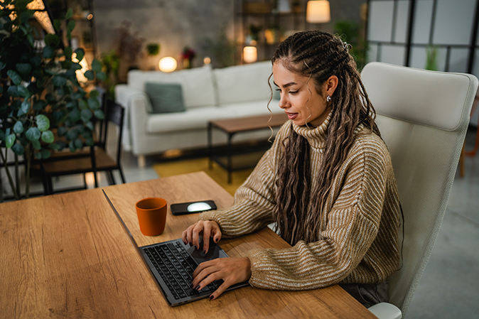 Young woman working on her laptop at home