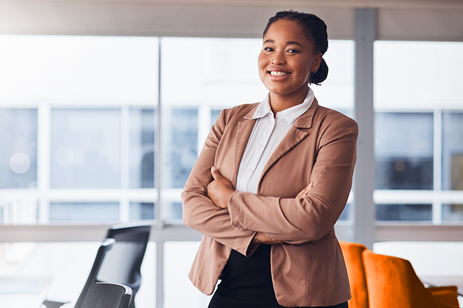 Black woman, business and portrait with a smile in office with pride for career or job as leader. Young entrepreneur person happy about growth, development and mindset to grow startup company.