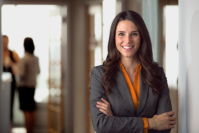 Young woman in an office wearing a business suit