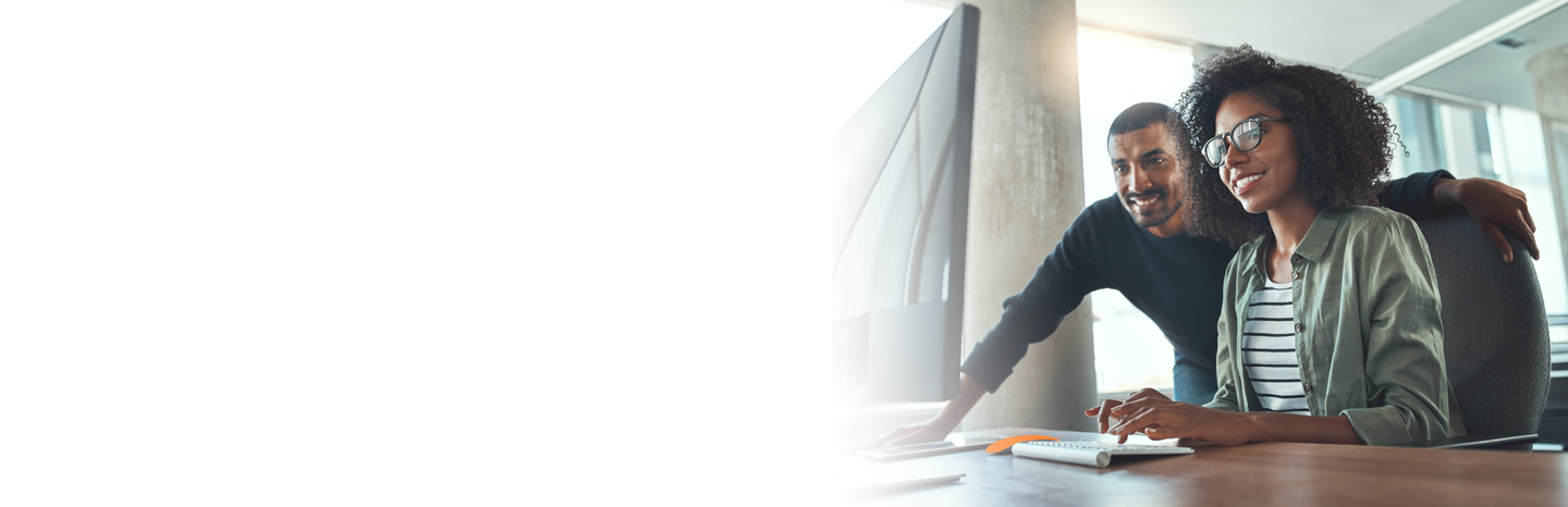 Two professionals working together on the computer in the office