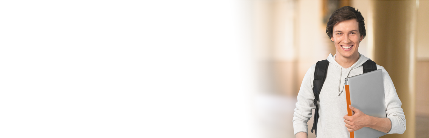 Young man holding a laptop in a college hallway
