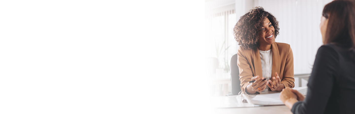 Young woman in an office consulting with another woman