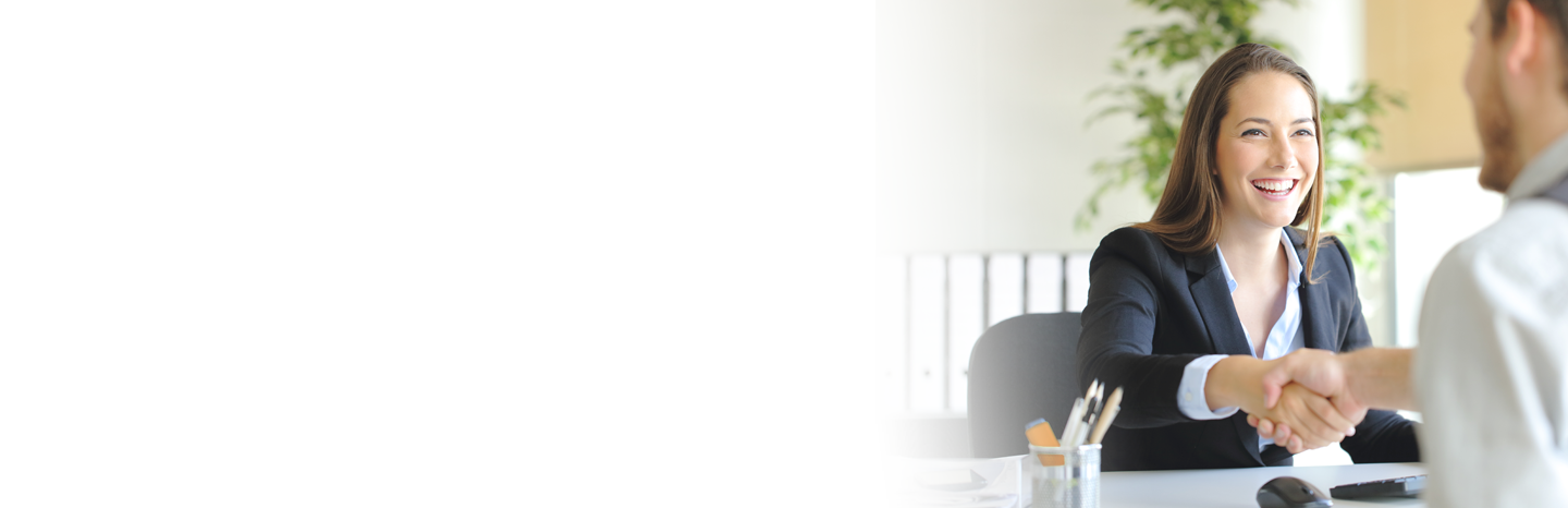Young woman shaking a man's hand in an office