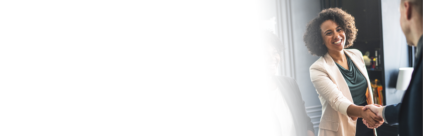 Young woman shaking the hand of a business partner