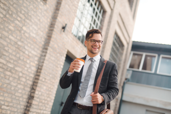 Man walking to work with a coffee