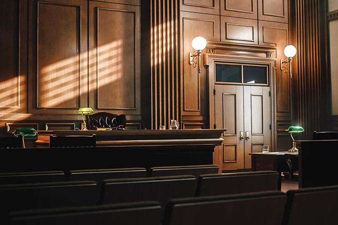 Empty American Style Courtroom. Supreme Court of Law and Justice Trial Stand. Courthouse Before Civil Case Hearing Starts. Grand Wooden Interior with Judge's Bench, Defendant's and Plaintiff's Tables.