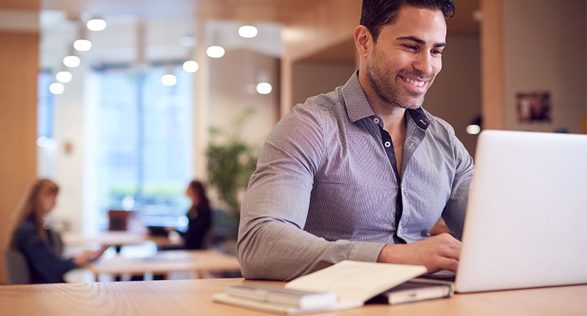 Man on laptop smiling