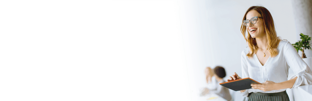 Young woman smiling while holding a tablet